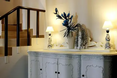a white cabinet with two lamps on top of it at Cyan Villa in Anavissos