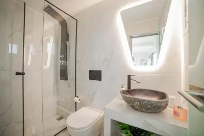 a bathroom with a sink and a toilet at Paradise Heated Jacuzzi with Acropolis View in Athens