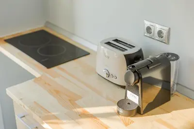 a kitchen counter with a hair dryer and a toaster at Paradise Heated Jacuzzi with Acropolis View in Athens