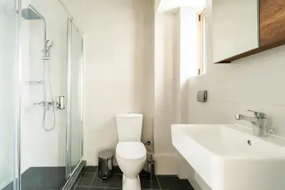 a bathroom with a toilet and a sink and a shower at Elysee apartment 9B in Athens