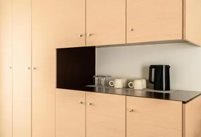 a kitchen with wooden cabinets and a coffee maker at Elysee apartment 9B in Athens