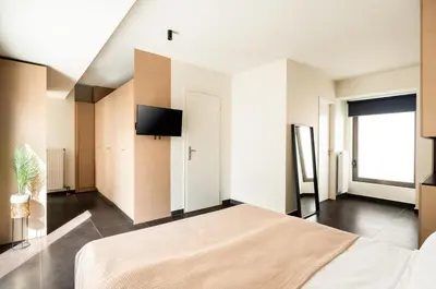 a bedroom with a bed and a flat screen tv at Elysee apartment 9B in Athens