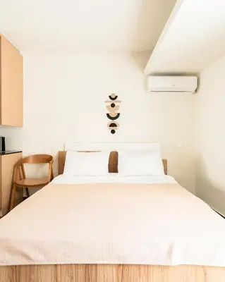 a bedroom with a bed with white sheets at Elysee apartment 9B in Athens