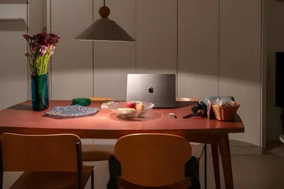 a table with a laptop and a bowl of fruit on it at Athenian Cypress House in Athens