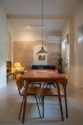 a dining room with a wooden table and chairs at Athenian Cypress House in Athens