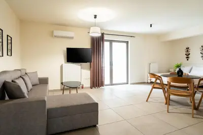 a living room with a couch and a table at Elysee apartment 5 in Athens