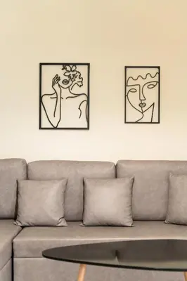 two framed art prints on the wall above a couch at Elysee apartment 5 in Athens