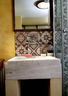 a bathroom with a sink and a mirror at OneStep mini apartment next to Kallimarmaro Stadium in Athens
