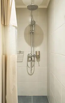 a shower with a shower curtain in a bathroom at Elysee apartment 6 in Athens