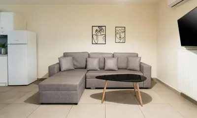 a living room with a couch and a table at Elysee apartment 6 in Athens