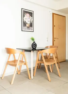 a dining room table with two chairs and a vase on it at Elysee apartment 8 in Athens