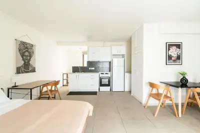 a kitchen and dining room with a table and chairs at Elysee apartment 8 in Athens