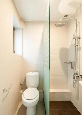 a small bathroom with a toilet and a shower at Elysee apartment 8 in Athens