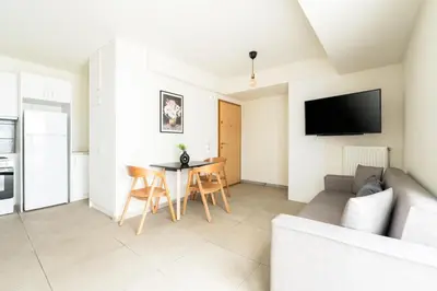 a living room with a couch and a table at Elysee apartment 8 in Athens