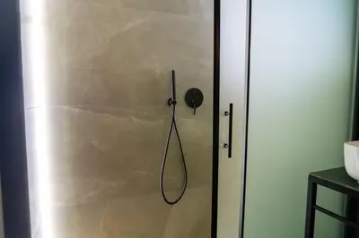 a shower in a bathroom with a glass door at Central Athens Spacious Boho Retreat In Acropolis in Athens