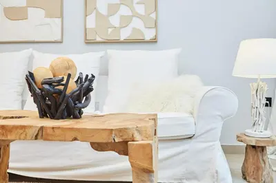 a living room with a white couch and a wooden coffee table at Calypso Apartment in Athens