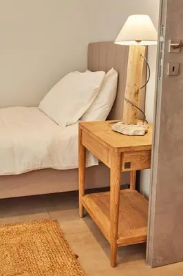 a bedroom with a bed and a table with a lamp at Calypso Apartment in Athens