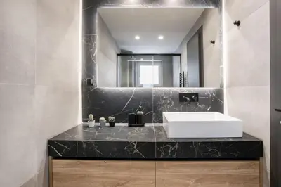 a bathroom with a sink and a mirror at Astoria - Luxury 2-BR Apartment in Athens in Athens