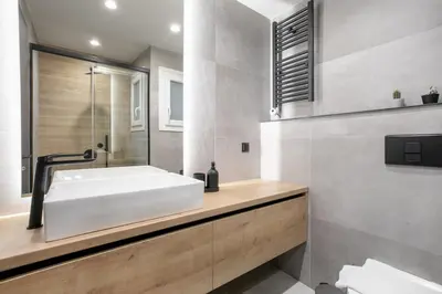 a bathroom with a white tub and a sink at Astoria - Luxury 2-BR Apartment in Athens in Athens