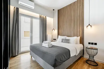 a bedroom with a large bed and a large window at Astoria - Luxury 2-BR Apartment in Athens in Athens