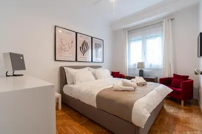 a bedroom with a large bed and red chairs at Artistic Elegance in central Athens, Pangrati in Athens