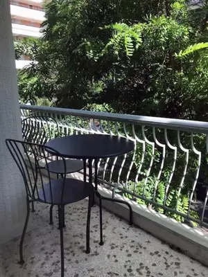 a black table and a chair on a balcony at Artistic Elegance in central Athens, Pangrati in Athens