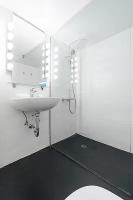 a white bathroom with a sink and a mirror at Artistic Elegance in central Athens, Pangrati in Athens