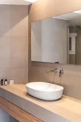 a bathroom with a white sink on a counter at Monastiraki Living Flats by UPSTREET in Athens