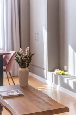 a vase with flowers sitting on a wooden table at Monastiraki Living Flats by UPSTREET in Athens