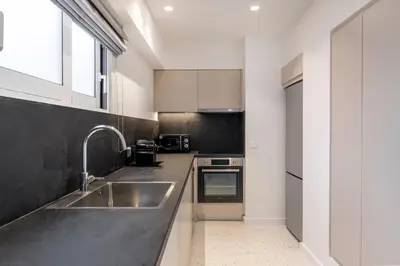 a kitchen with a sink and a counter top at Monastiraki Living Flats by UPSTREET in Athens