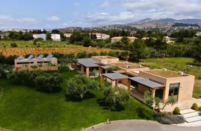 an aerial view of a house with a green yard at Athens Motorhome Park GEORGETOWN RV in Yialoú