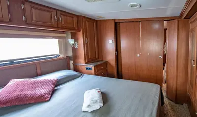 a room with a bed in the middle of a boat at Athens Motorhome Park GEORGETOWN RV in Yialoú