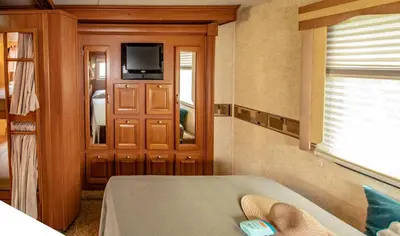 a room with a tv and a door with a window at Athens Motorhome Park GEORGETOWN RV in Yialoú