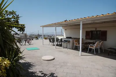 a patio with a house with a table and chairs at No7 Theo Homeybee Exarcheia in Athens