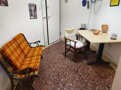 a room with a table and a chair and a table and a table at No7 Theo Homeybee Exarcheia in Athens