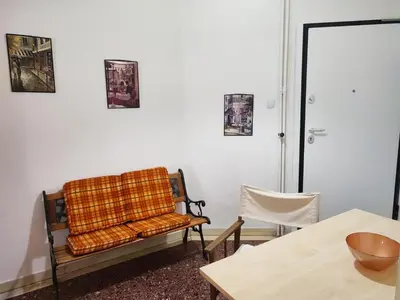 a living room with a chair and a table at No7 Theo Homeybee Exarcheia in Athens