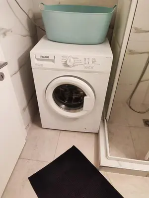 a washing machine with a bowl on top of it at No7 Theo Homeybee Exarcheia in Athens