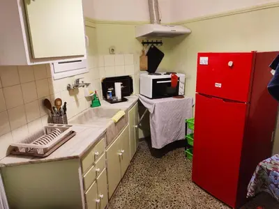 a kitchen with a sink and a red refrigerator at No7 Theo Homeybee Exarcheia in Athens