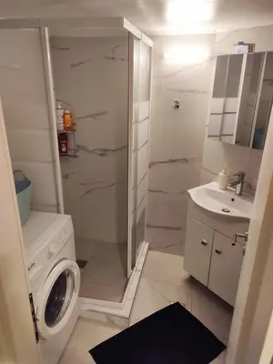 a bathroom with a washing machine and a sink at No7 Theo Homeybee Exarcheia in Athens