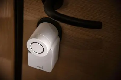 a white speaker hanging on a wooden door at Kaf23 - 2BR apt with Balcony in Athens