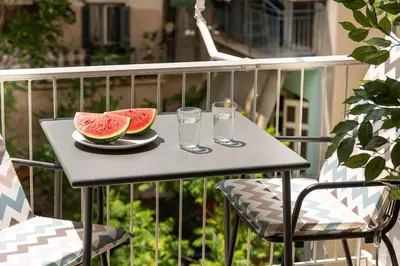 a table with two glasses and a plate of watermelon at Kaf23 - 2BR apt with Balcony in Athens