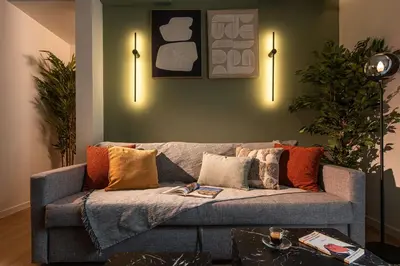 a living room with a gray couch with colorful pillows at Kaf23 - 2BR apt with Balcony in Athens