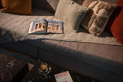 a book sitting on top of a bed at Kaf23 - 2BR apt with Balcony in Athens