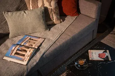 a book sitting on top of a couch at Kaf23 - 2BR apt with Balcony in Athens