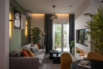a living room with a couch and a table at Kaf23 - 2BR apt with Balcony in Athens