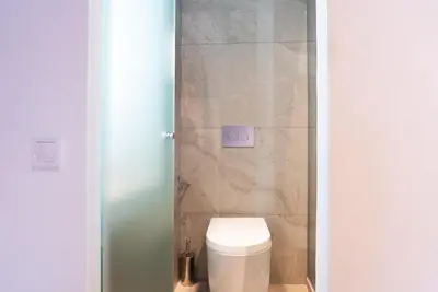 a bathroom with a white toilet in a room at The Athenian Penthouse in Syntagma Square in Athens