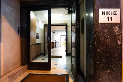 a hallway in a building with a sign that reads music at The Athenian Penthouse in Syntagma Square in Athens