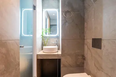 a bathroom with a sink and a toilet and a mirror at The Athenian Penthouse in Syntagma Square in Athens