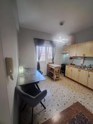 a kitchen with a table and a chair in a room at Exarchia Penthouse Cozy & Central in Athens