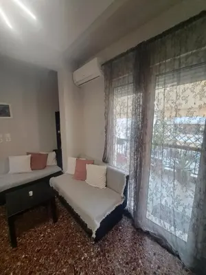 a room with a bed and a couch and a window at Exarchia Penthouse Cozy & Central in Athens